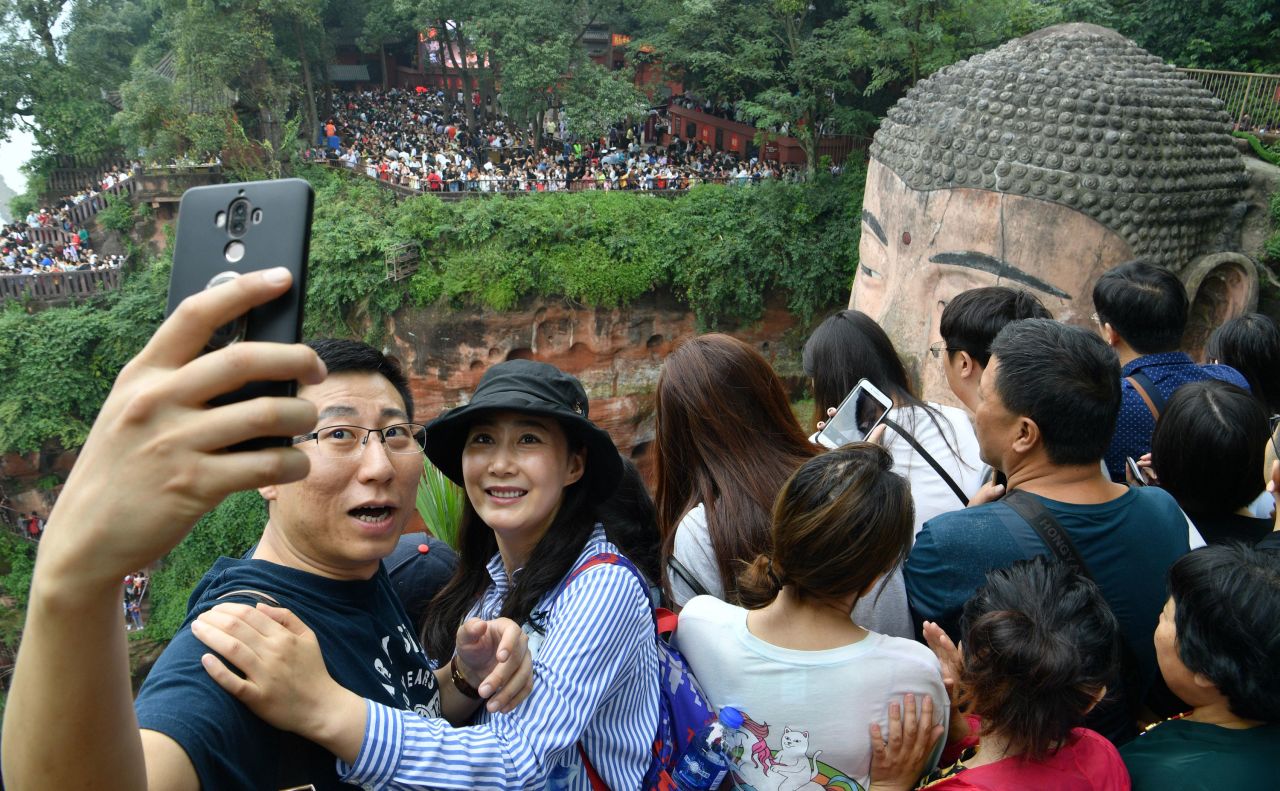 Tourists crowd the Leshan Giant Buddha in China's Sichuan province during the National Day holiday in 2019.