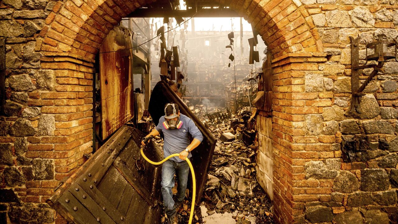 Cellar worker Jose Juan Perez extinguishes hotspots at Castello di Amorosa outside Calistoga on Monday.  