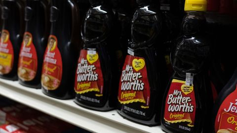 Mrs. Butterworths products seen displayed on supermarket shelves.