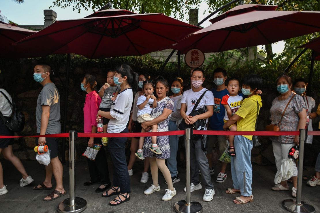 Tourists wearing face masks line up outside the Yellow Crane Tower in Wuhan, China on September 3.