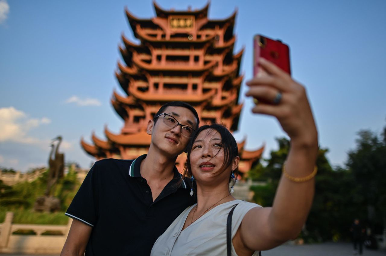 Tourists take a selfie at the the Yellow Crane Tower in Wuhan on September 3, 2020.
