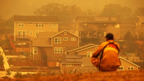 A firefighter looks towards a home that was destroyed by the Glass Incident Fire on September 28, 2020 in Santa Rosa, California.