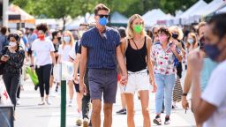 People wear protective face masks while shopping at the Union Square Greenmarket as the city continues Phase 4 of re-opening following restrictions imposed to slow the spread of coronavirus on August 26, 2020 in New York City. The fourth phase allows outdoor arts and entertainment, sporting events without fans and media production. 