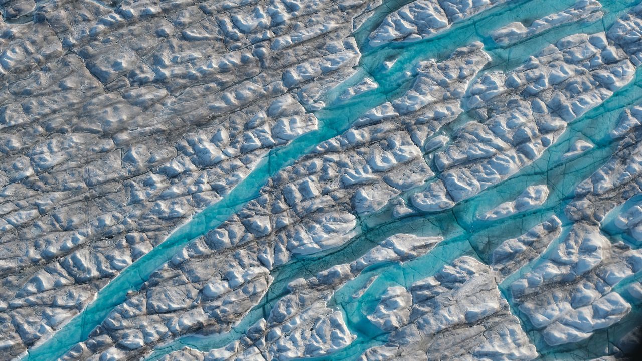 Meltwater carves into the ice sheet near the Sermeq Avangnardleq glacier in Greenland in August 2019.