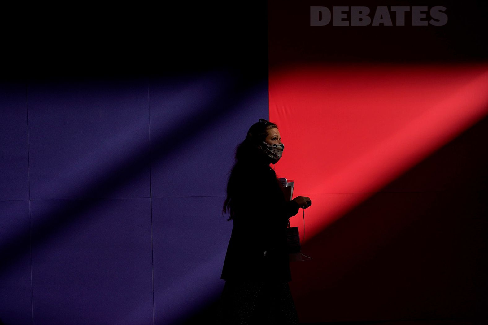 A member of the production team walks toward the stage ahead of the debate.