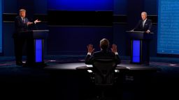 Moderator Chris Wallace of Fox News, center, gesturing during the first presidential debate between President Donald Trump, left, and Democratic presidential candidate former Vice President Joe Biden, right, Tuesday, Sept. 29, 2020, at Case Western University and Cleveland Clinic, in Cleveland, Ohio. 