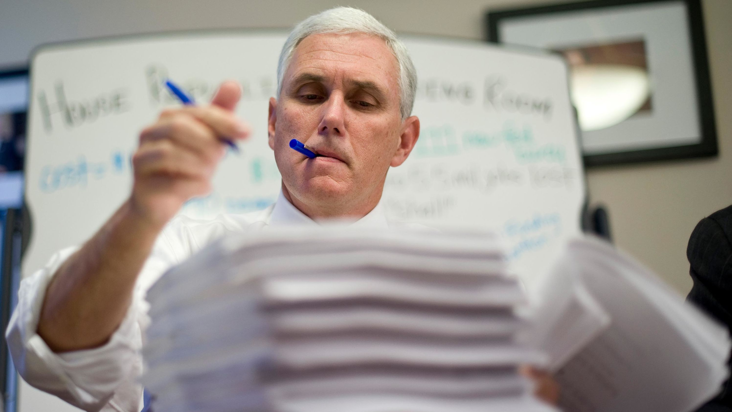 Pence makes marks on a House health-care bill in 2009.