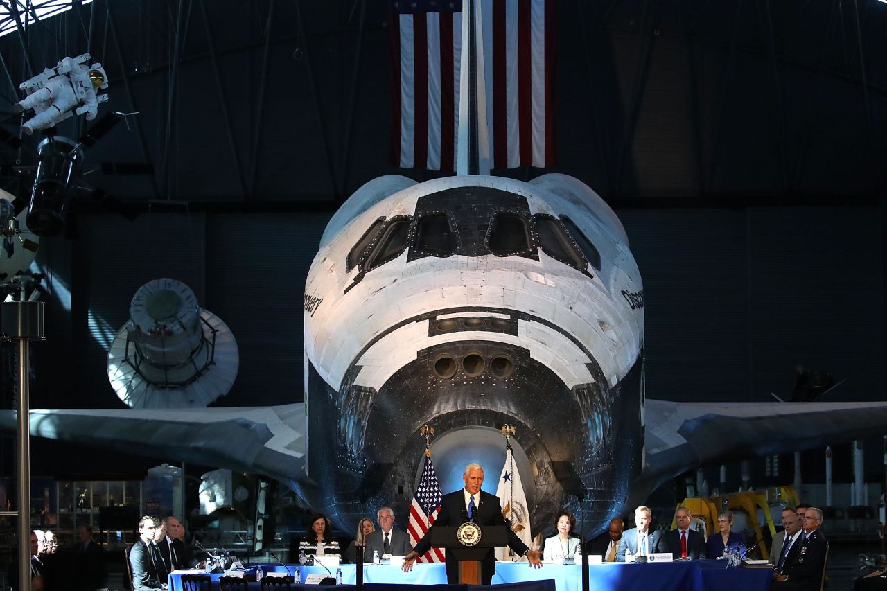 The Space Shuttle Discovery is the backdrop as Pence speaks during the inaugural meeting of the National Space Council in October 2017.