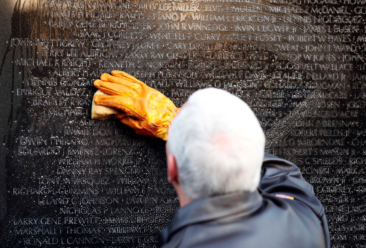 Pence cleans a portion of the wall at the Vietnam Veterans Memorial in November 2017.