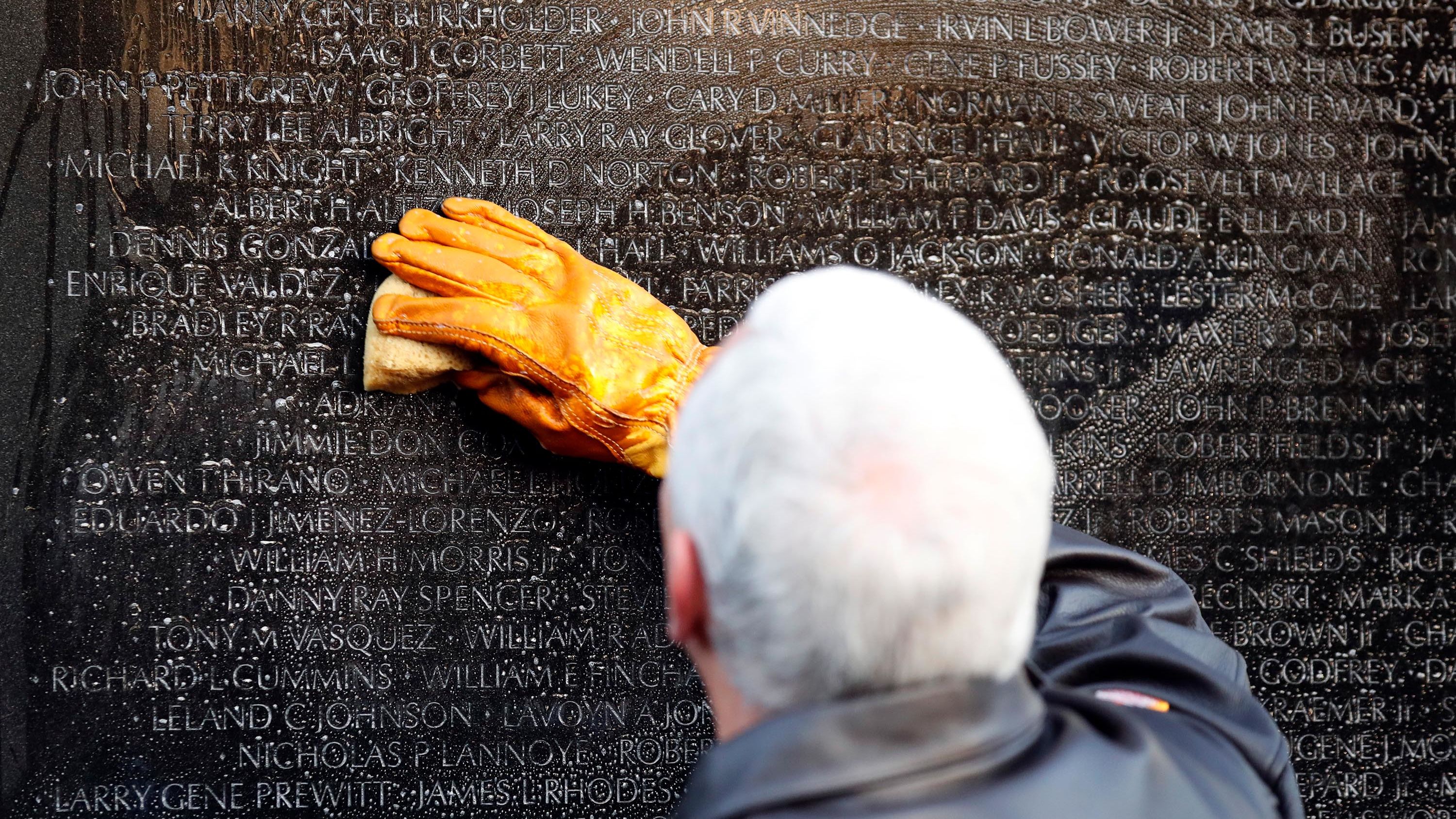 Pence cleans a portion of the wall at the Vietnam Veterans Memorial in November 2017.
