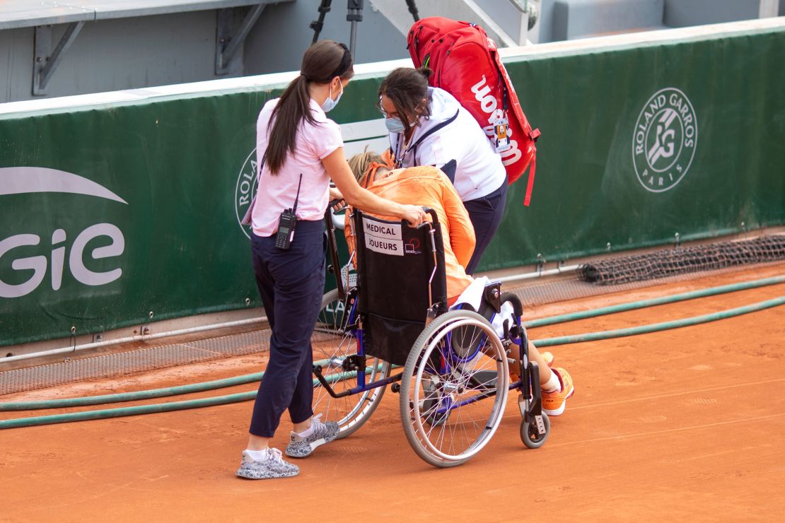 Bertens is taken off the court in a wheelchair after winning her marathon match against Errani.