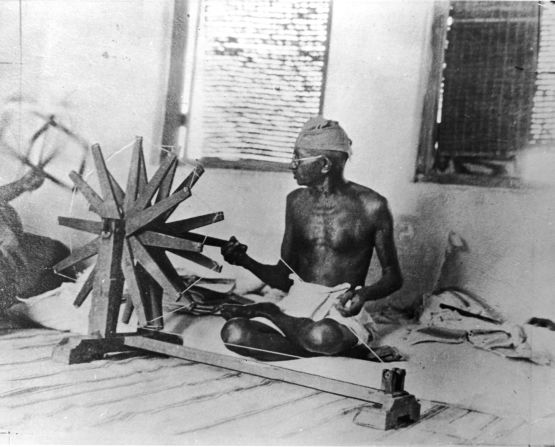 Gandhi uses a spinning wheel circa 1930. He urged Indians to spin their own cloth while boycotting British textiles. The wheel became a symbol of India's fight for independence. 