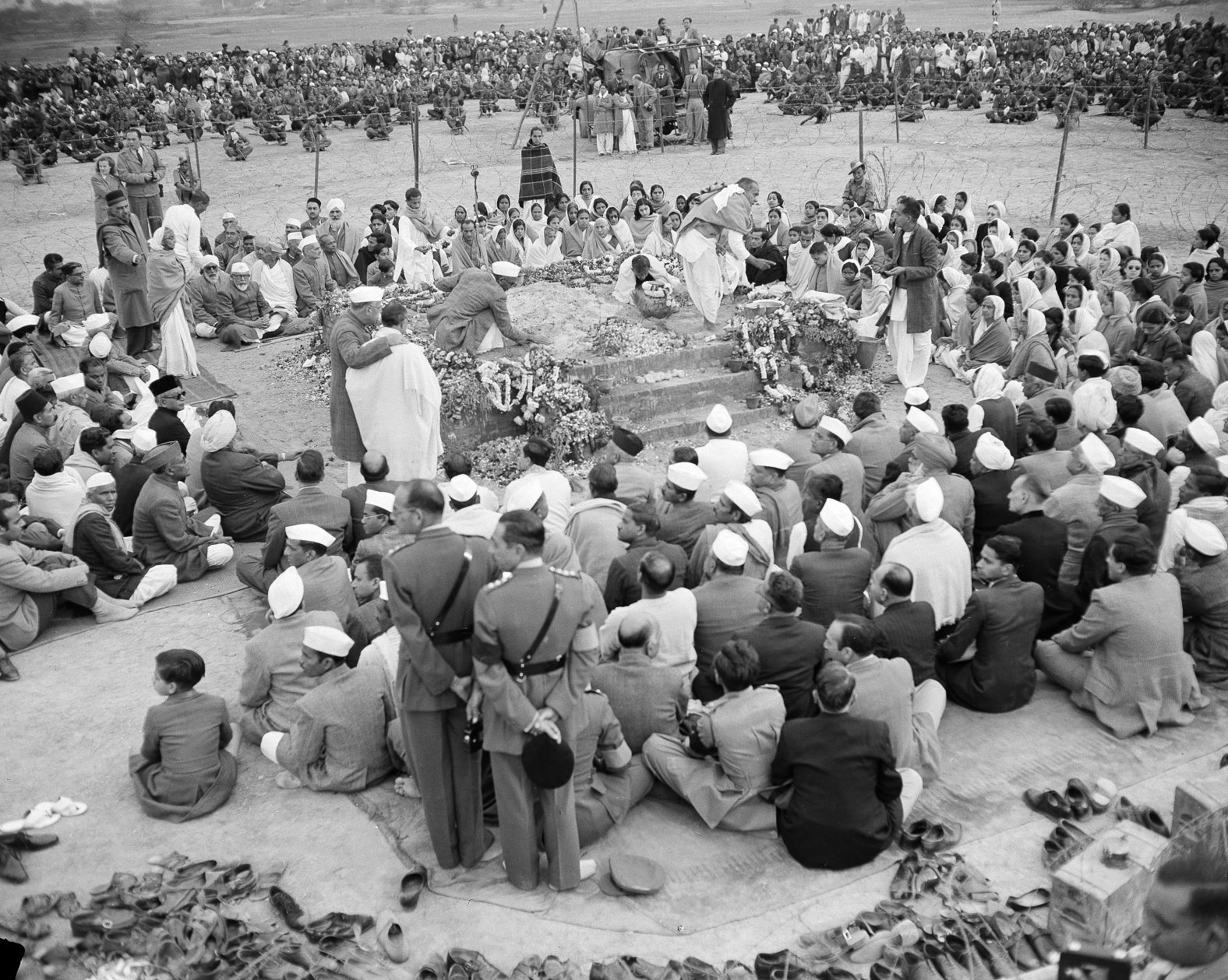 Gandhi's followers surround a flower-decked platform holding his ashes the day after he was cremated in 1948.