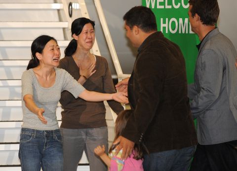 The families of Euna Lee, left, and Laura Ling greet them in California after their release from North Korea.	