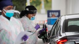 Medical technicians work at a drive-thru coronavirus disease (COVID-19) testing facility at the Regeneron Pharmaceuticals company's Westchester campus in Tarrytown, New York, U.S. September 17, 2020. Picture taken September 17, 2020. Brendan McDermid/Reuters