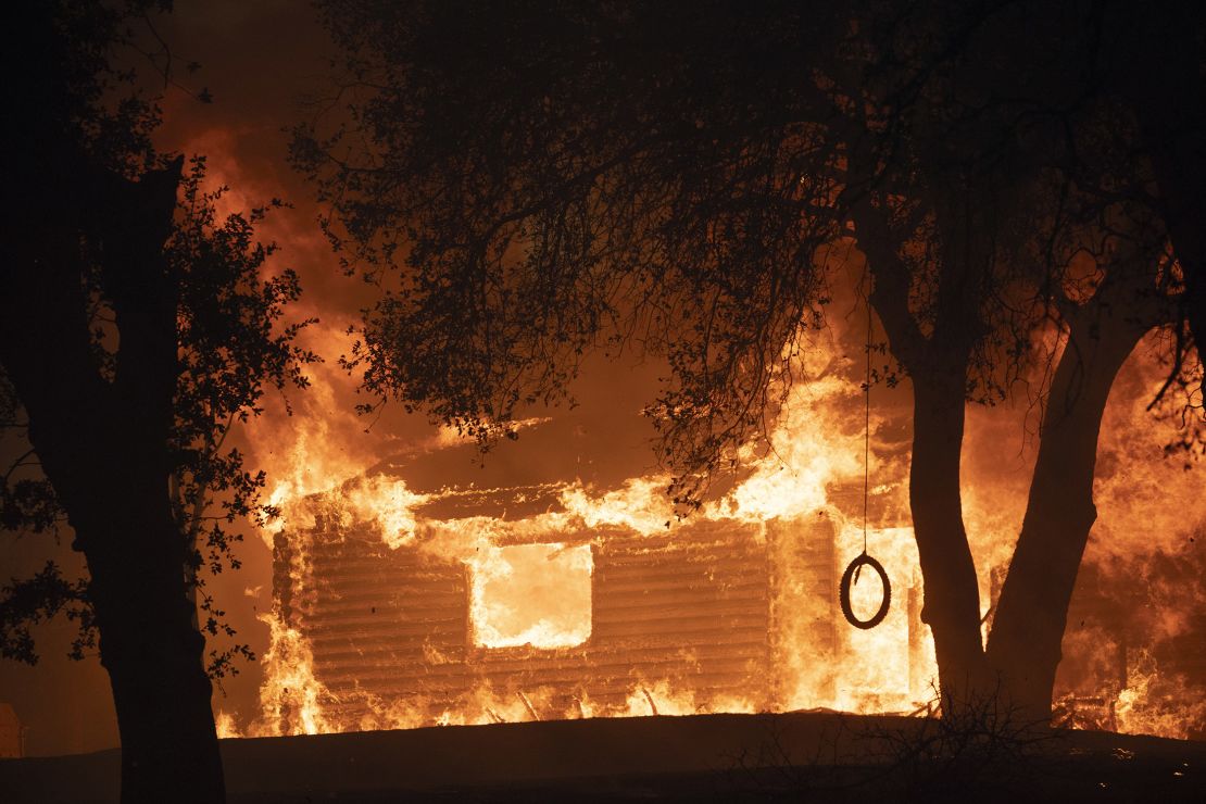 A house is seen burst into flames during the Zogg fire near the town of Igo.