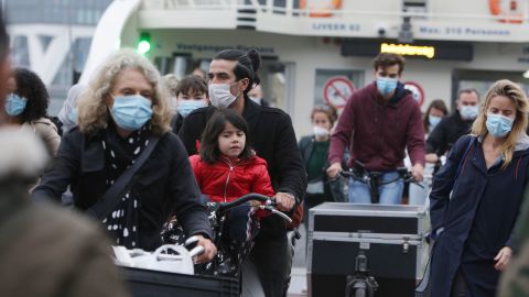 Locals wear masks at a ferry at IJ river in Amsterdam as face coverings become mandatory in the Netherlands.