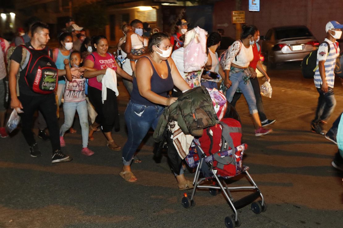 Hundreds of people walk along a highway in San Pedro Sula on Wednesday.