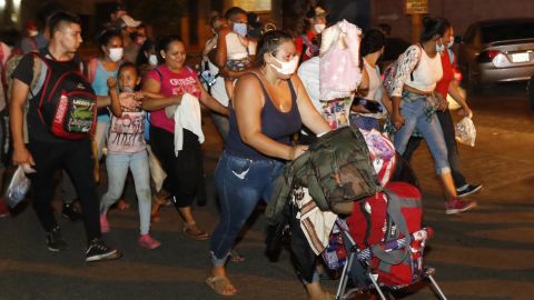 Hundreds of people walk along a highway in San Pedro Sula on Wednesday.