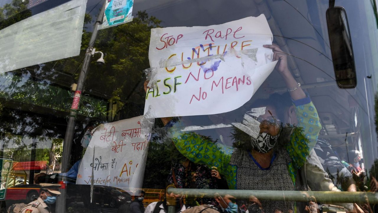 Protestors holding signs from a bus during a demonstration in New Delhi, India, on September 30, after the death of a 19-year-old woman who was allegedly gang raped.