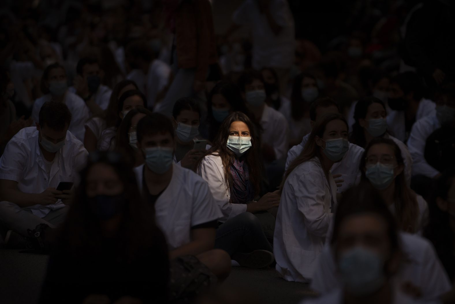 Medical residents sit in the middle of a street as they protest their working conditions in Barcelona, Spain, on September 28.