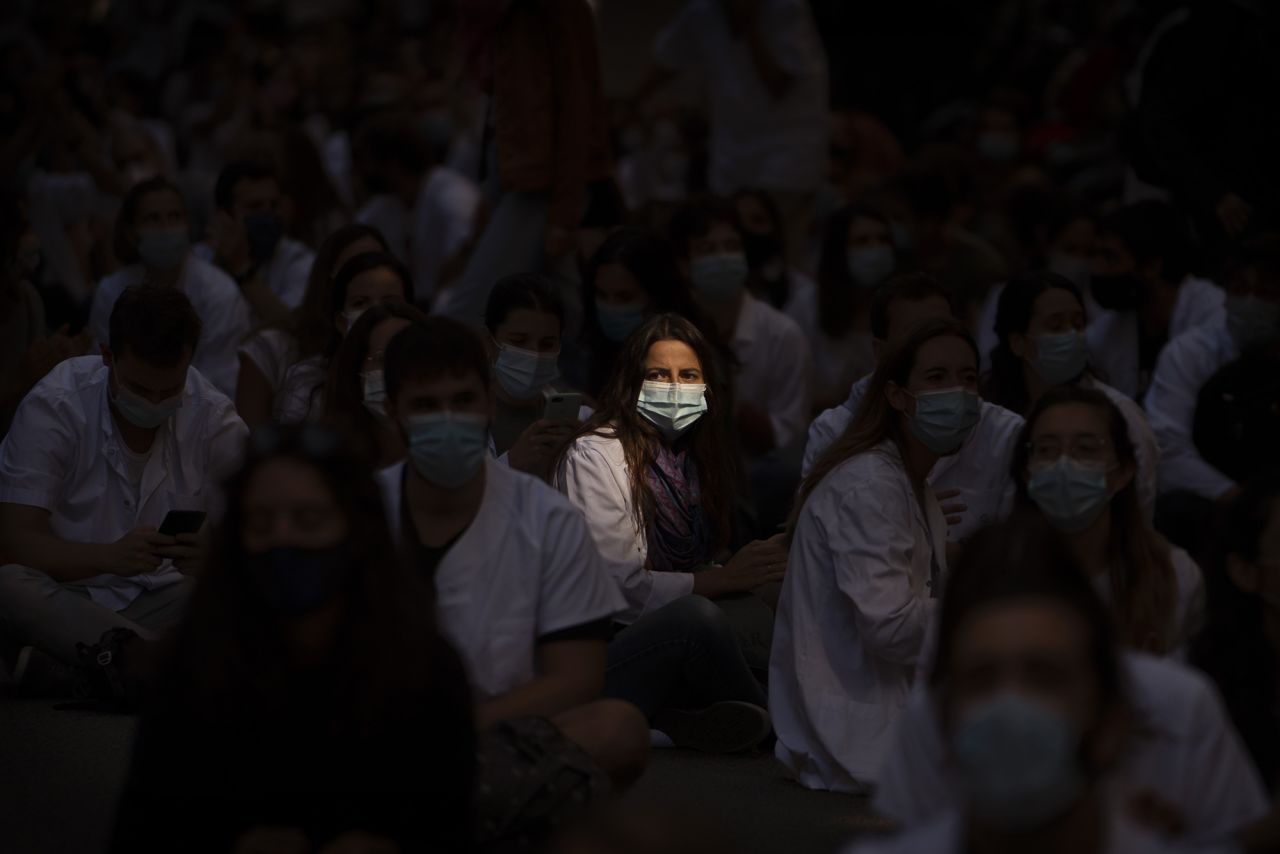 Medical residents sit in the middle of a street as they protest their working conditions in Barcelona, Spain, on September 28.