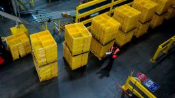 A man works at a distrubiton station at the 855,000-square-foot Amazon fulfillment center in Staten Island, one of the five boroughs of New York City, on February 5, 2019. - Inside a huge warehouse on Staten Island thousands of robots are busy distributing thousands of items sold by the giant of online sales, Amazon. (Photo by Johannes EISELE / AFP)        (Photo credit should read JOHANNES EISELE/AFP via Getty Images)