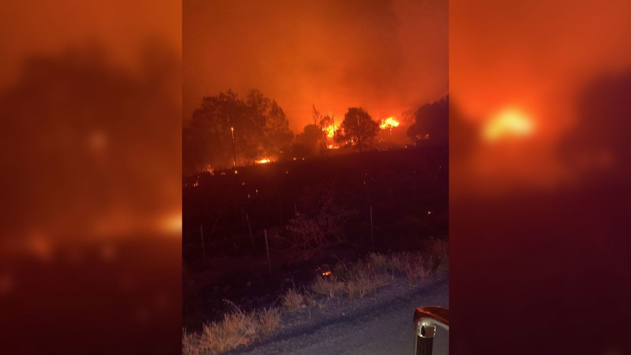 Flames burn near Jan Zakin's home in St. Helena, California.