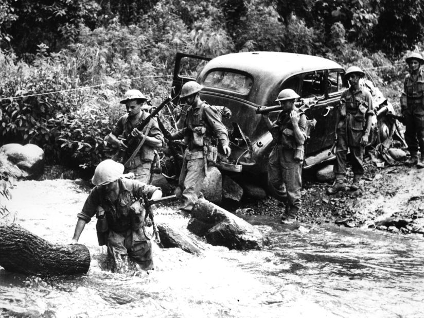 <strong>Battle of Kohima-Imphal:</strong> Often overlooked, the Battle for Kohima/Imphal is considered a decisive turning point for WWII. In this image, Corporal Edwards leads soldiers of 14th Army through a torrent of water near Kohima during the Battle for Kohima-Imphal in 1944. 