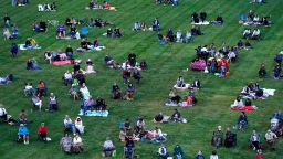 People are socially distanced as they listen to music of the Kansas City Symphony on the lawn at the Liberty Memorial Saturday, Sept. 19, 2020, in Kansas City, Mo. (AP Photo/Charlie Riedel)