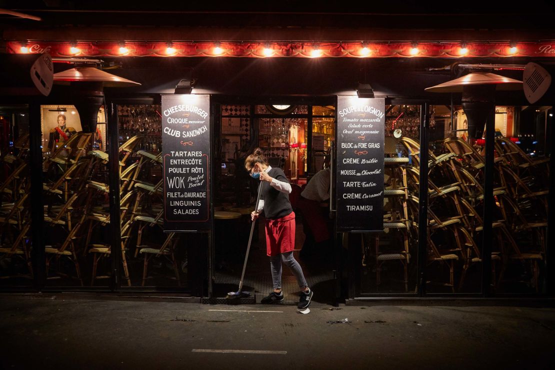 A worker at a Paris bar closes up early to comply with new Covid-19 restrictions forcing bars and cafes in the French capital to close at 10 p.m. on September 28.