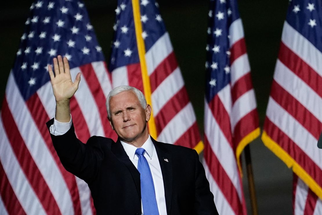 ice President Mike Pence waves after speaking during a campaign rally at Newport News/Williamsburg International Airport on September 25, 2020 