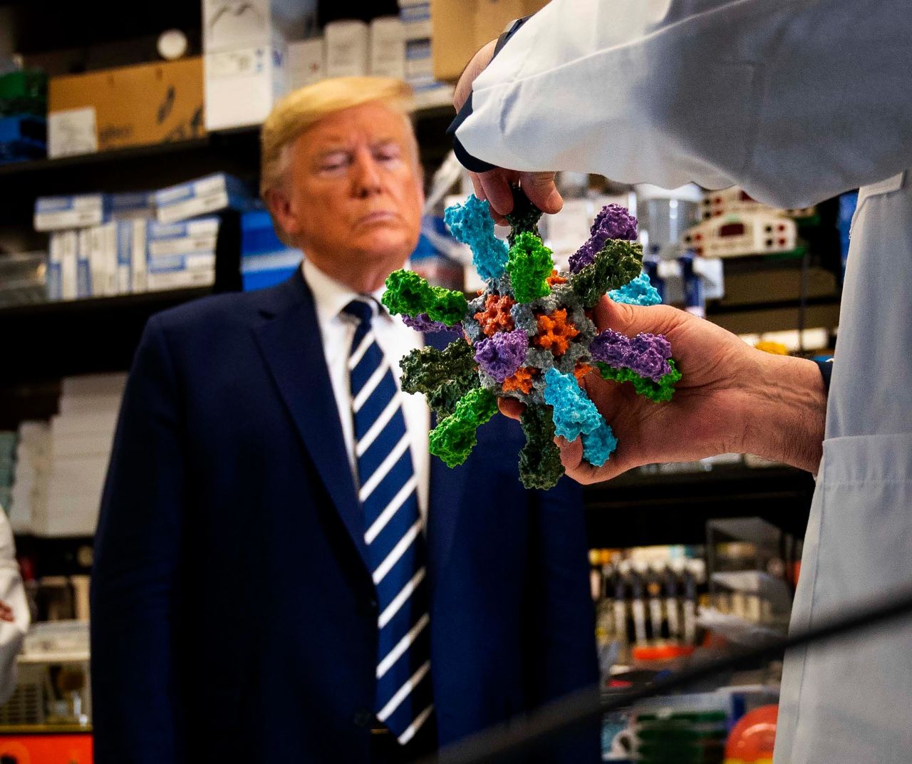 Trump looks at a coronavirus model while touring the National Institutes of Health in March 2020.