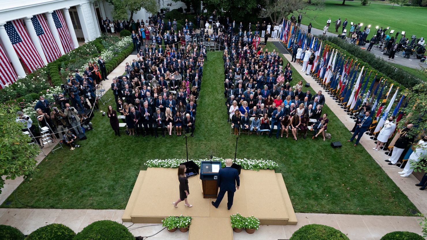 Judge Amy Coney Barrett walks to the microphone after President Donald Trump, right, announced Barrett as his nominee to the Supreme Court, in the Rose Garden at the White House on Sept. 26, 2020. Fr. John Jenkins can be seen seated in the right section, third row.