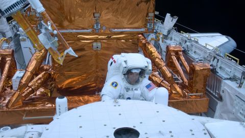 STS-125 Mission Specialist Mike Massimino is pictured here working with the Hubble Space Telescope in the cargo bay of the Earth-orbiting space shuttle Atlantis in 2009.