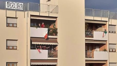 Michele D'Alpaos wrote Paola Agnelli's name on a bedsheet and hung it on top of his apartment building in a gesture to show his love.