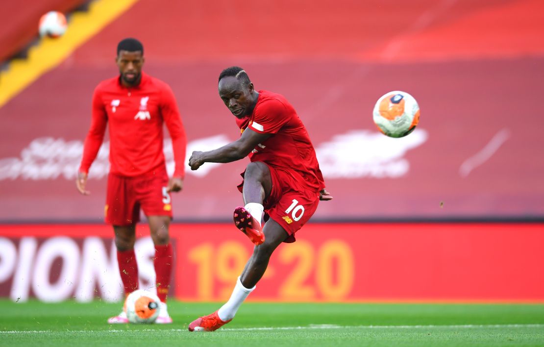 Mane warms up ahead of Liverpool's game against Chelsea.
