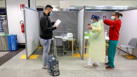 A passenger waits to undergo a swab test at a Covid-19 rapid test facility at Fiumicino Airport in Rome, September 25.