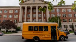 A school bus sits parked outside Midwood High School in the Midwood neighborhood in the Brooklyn borough of New York, U.S., on Thursday, Sept. 24, 2020. New York City Mayor Bill de Blasio said a recent uptick of coronavirus cases in south Brooklyn and Queens neighborhoods requires "urgent action," including stepped-up testing, education and enforcement. Photographer: Amir Hamja/Bloomberg via Getty Images