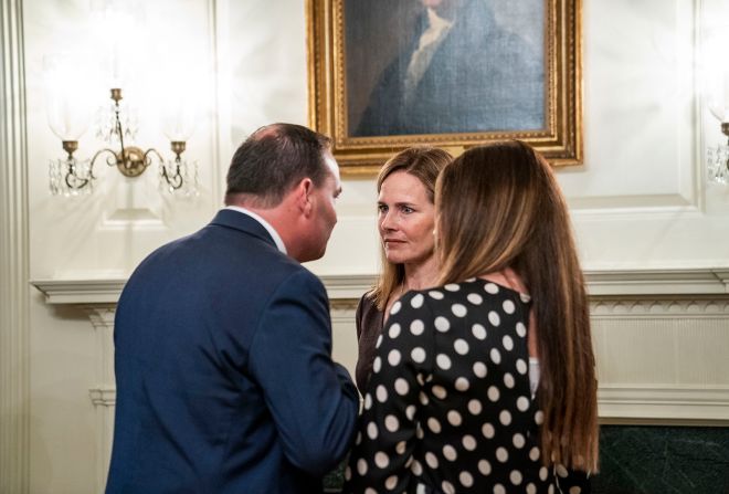 US Sen. Mike Lee and his wife, Sharon, chat with Barrett. Lee has also tested positive since the reception.