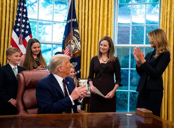 The first lady applauds Barrett in the Oval Office prior to the official announcement.