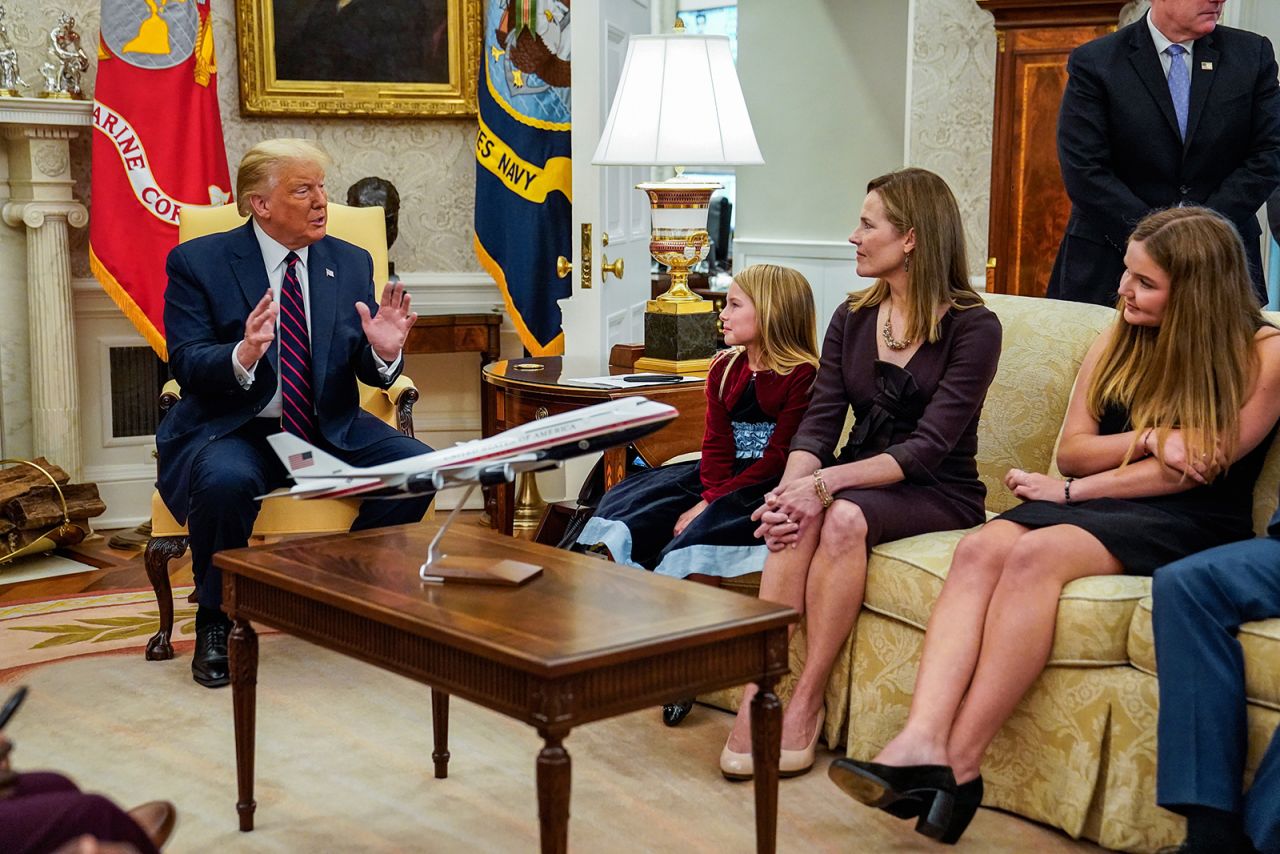 Barrett and a couple of her children listen to Trump in the Oval Office.