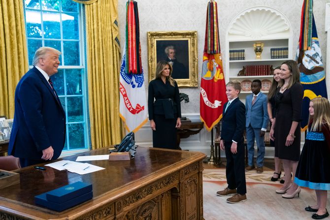 The Trumps welcome Barrett and her children to the Oval Office.