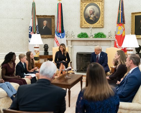 Trump smiles while chatting with Barrett's children.