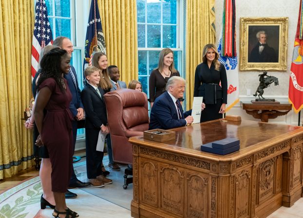 The Barretts and the Trumps pose for a photo.