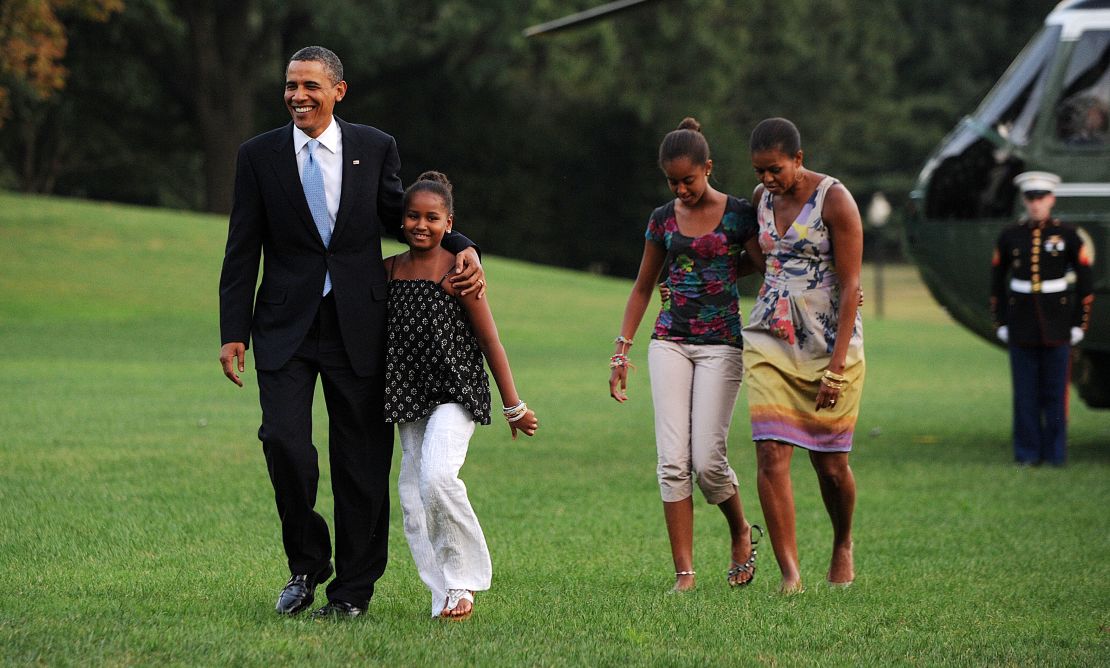Barack and Michelle Obama return from vacation with daughters Sasha (left) and Malia in August 2010.