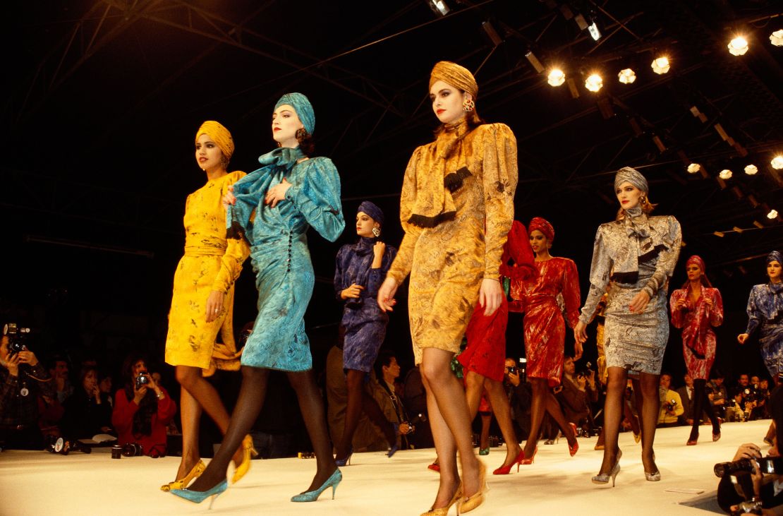 Models wear bright colored suits with matching turbans by  designer Kenzo Takada at his Autumn-Winter show in Paris, 1986.
