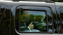 President Donald Trump wears a protective mask while giving a thumbs up as he is driven in a motorcade past supporters outside of Walter Reed National Military Medical Center in Bethesda, Maryland, U.S., on Sunday, Oct. 4, 2020. Trump briefly left his hospital in a car to greet supporters gathered outside, after posting a video on Twitter saying he was about to make a surprise visit. Photographer: Graeme Sloan/Bloomberg via Getty Images