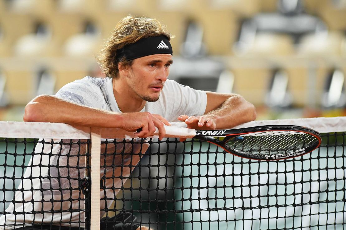 Zverev leans on the net during his match against Pierre-Hugues Herbert at the French Open.