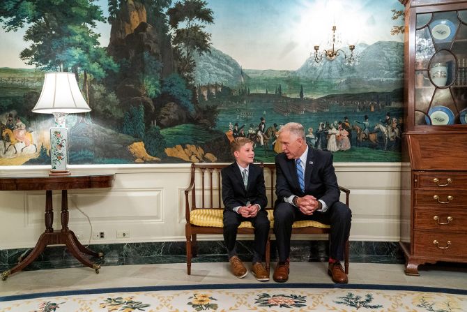 Sen. Thom Tillis, who has now tested positive for coronavirus, talks with one of Barrett's children.